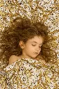 20250613_1117_Girl Sleeping on Pattern_remix_01jxkx4ygheber58kwb0wc9tv5.webp